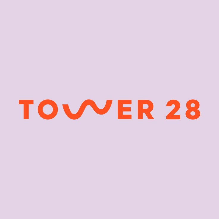 Tower 28 logo in orange text on a light lavender background