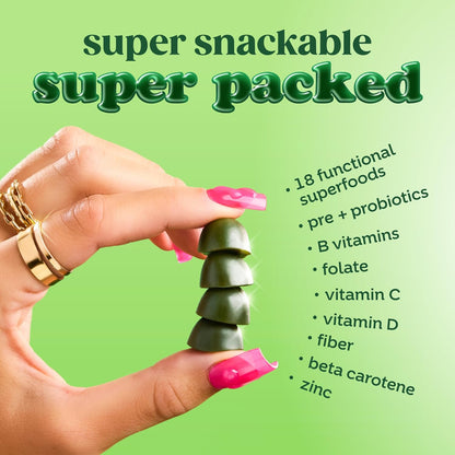 Hand holding a stack of green Bloom Supergreens gummies with text listing nutritional benefits on a green background