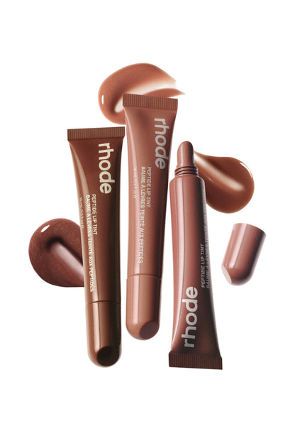 Brown lip balm tubes with 'rhode' branding on a white background