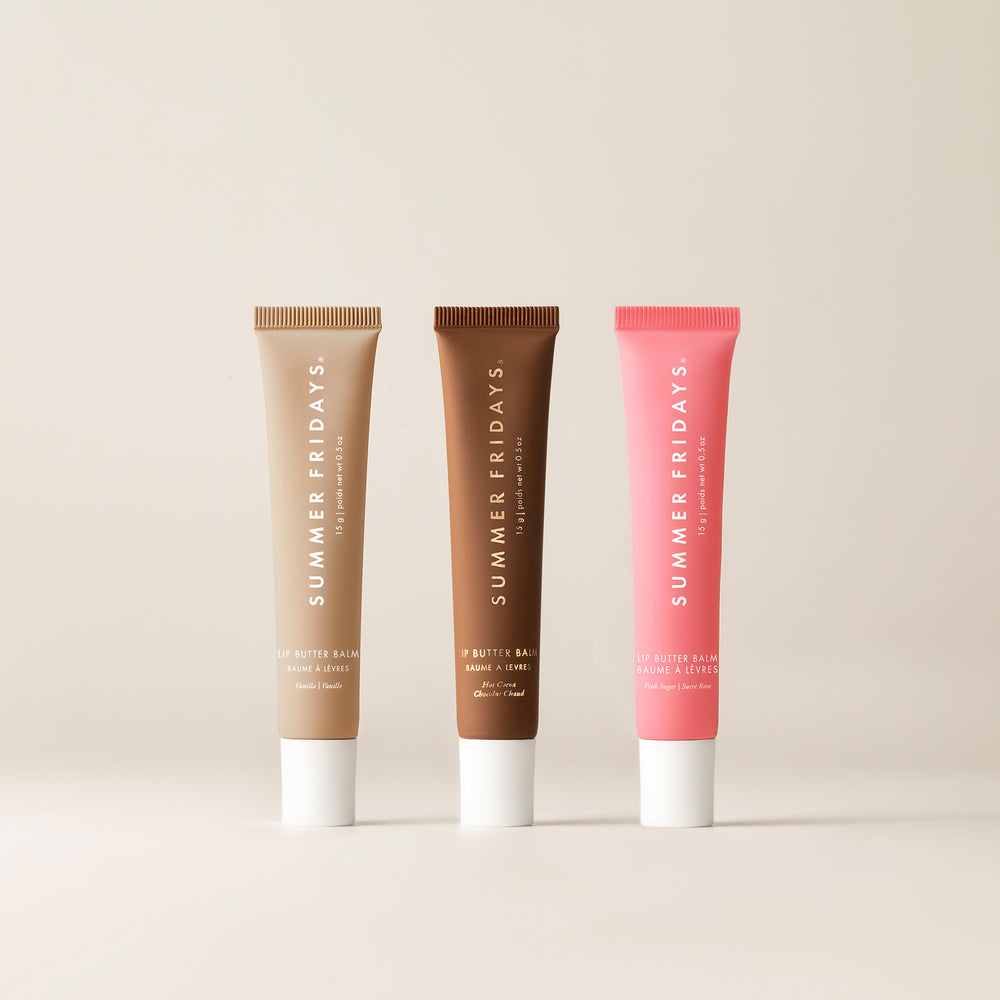 Three lip balm tubes from Summer Fridays on a beige background