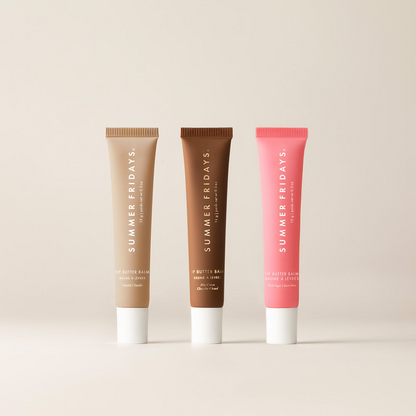 Three lip balm tubes from Summer Fridays on a beige background