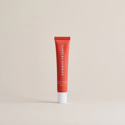 Red tube of Summer Fridays lip balm on a beige background