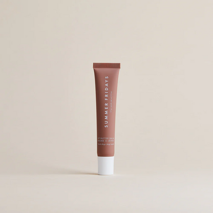 Brown tube of lip balm with 'Summer Fridays' branding on a beige background