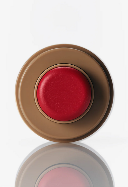Red cosmetic compact on a white background