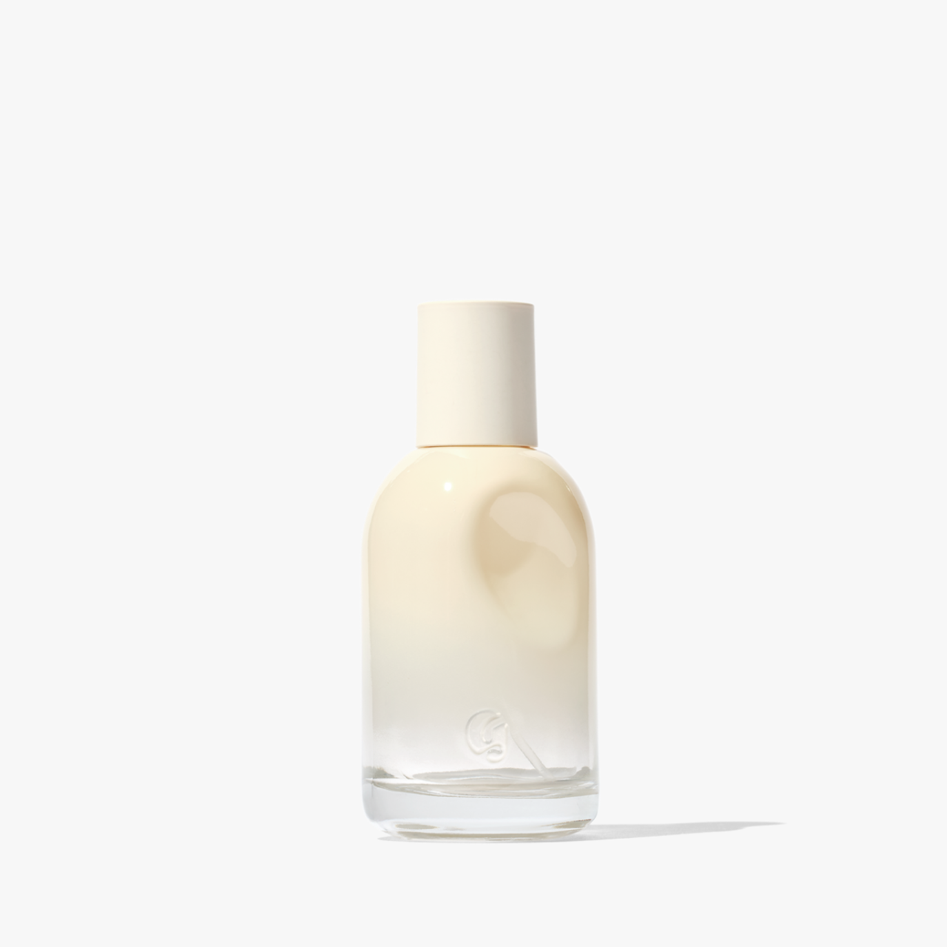 Cream-colored gradient bottle of Glossier You perfume on a white background