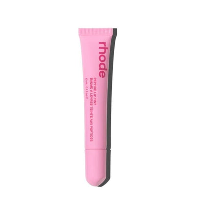 Pink tube of Rhode lip balm on a white background