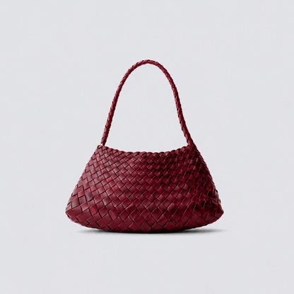 Maroon woven leather handbag on a light gray background