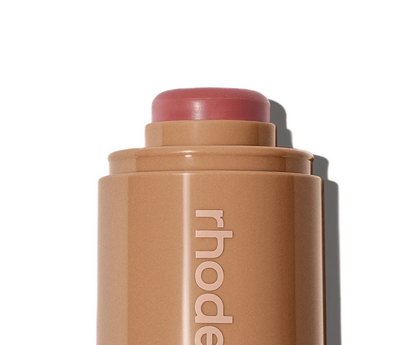 Cosmetic stick with 'rhode' branding on a white background